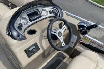 Slide: The Image of 2023 Sun Tracker SportFish 22 DLX dashboard with steering wheel and controls. - 3