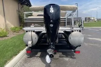 Slide: The Image of 2023 Sun Tracker SportFish 22 DLX pontoon boat with powerful 150 HP engine. - 9