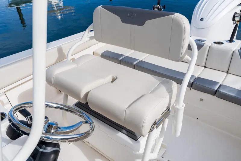 Slide: The Image of 2027 Sailfish 232 CC boat interior with cushioned seating and steering wheel. - 12