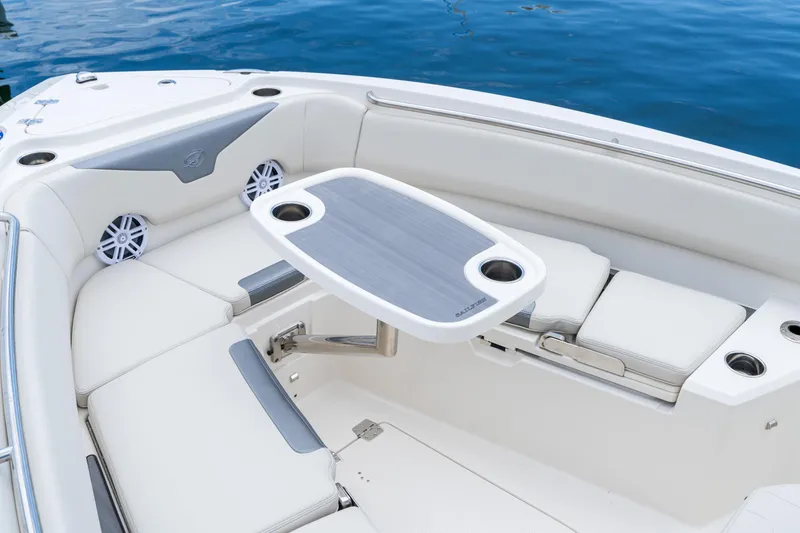 Slide: The Image of Luxurious seating area on 2027 Sailfish 232 CC boat with table and cup holders. - 23