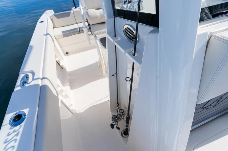 Slide: The Image of 2027 Sailfish 232 CC boat interior with fishing rod holders and seating. - 7