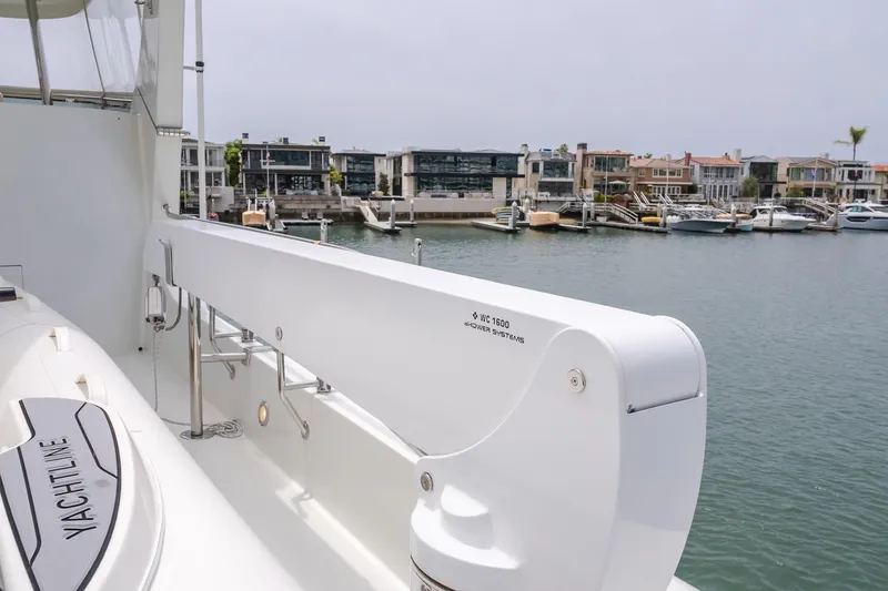Slide: The Image of 2006 Cheoy Lee 72' Raised Pilot House yacht docked in a marina with waterfront homes. - 10