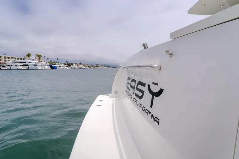 Slide: The Image of Cheoy Lee 72' Raised Pilot House yacht, 2006, docked in a marina with other boats. - 14