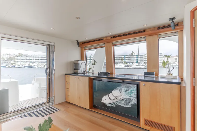 Slide: The Image of Luxurious interior of 2006 Cheoy Lee 72' Raised Pilot House yacht with marina view. - 19