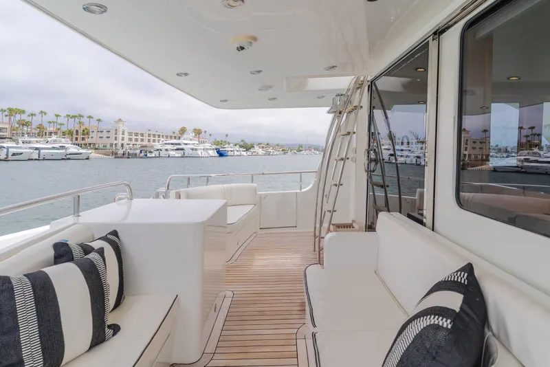 Slide: The Image of Luxurious 2006 Cheoy Lee 72' yacht deck with elegant seating and marina view. - 2
