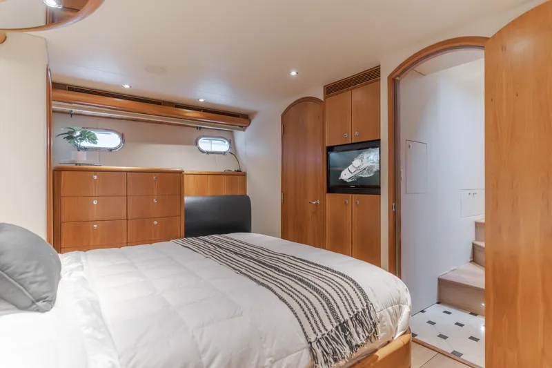 Slide: The Image of Luxurious bedroom interior of 2006 Cheoy Lee 72' Raised Pilot House yacht, featuring elegant wood finishes. - 31