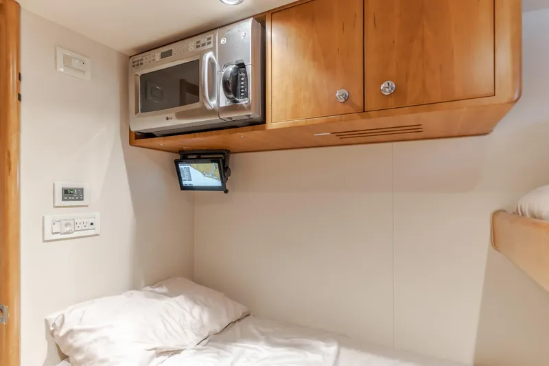 Slide: The Image of Cozy cabin interior of 2006 Cheoy Lee 72' Raised Pilot House with microwave and wooden cabinets. - 38