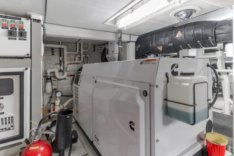 Slide: The Image of Engine room of 2006 Cheoy Lee 72' Raised Pilot House yacht with generator and control panels. - 44