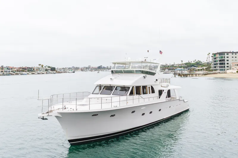 Slide: The Image of Luxurious 2006 Cheoy Lee 72' Raised Pilot House yacht cruising in a serene harbor. - 60