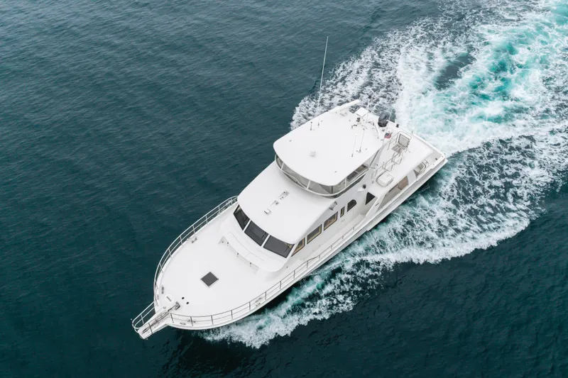 Slide: The Image of 2006 Cheoy Lee 72' Raised Pilot House yacht cruising on open water. - 62