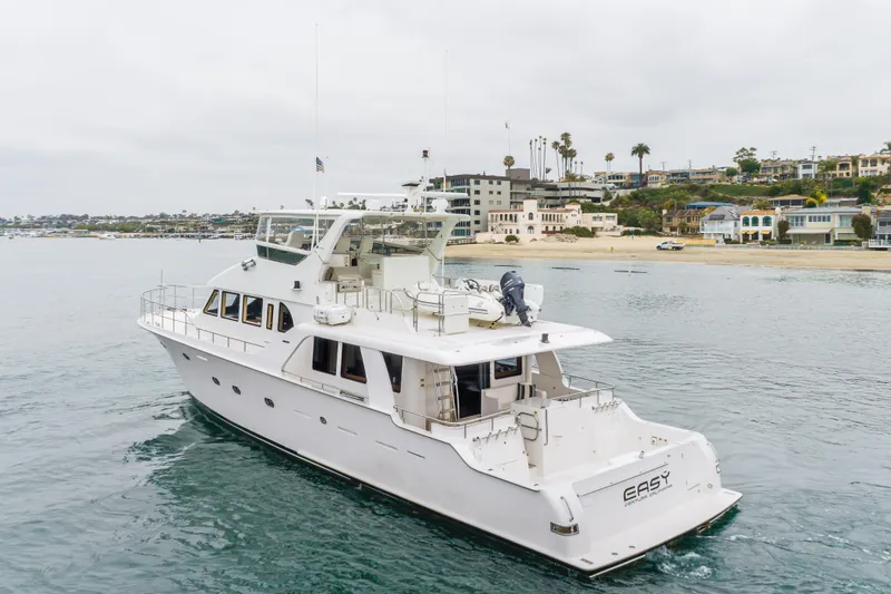 Slide: The Image of Luxury 2006 Cheoy Lee 72' Raised Pilot House yacht cruising near scenic coastline. - 68