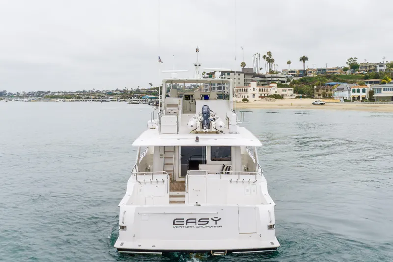 Slide: The Image of Luxury 2006 Cheoy Lee 72' Raised Pilot House yacht near scenic coastline. - 70