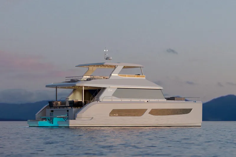 Slide: The Image of Luxurious 2026 ILIAD 60 yacht on serene water at sunset. - 2