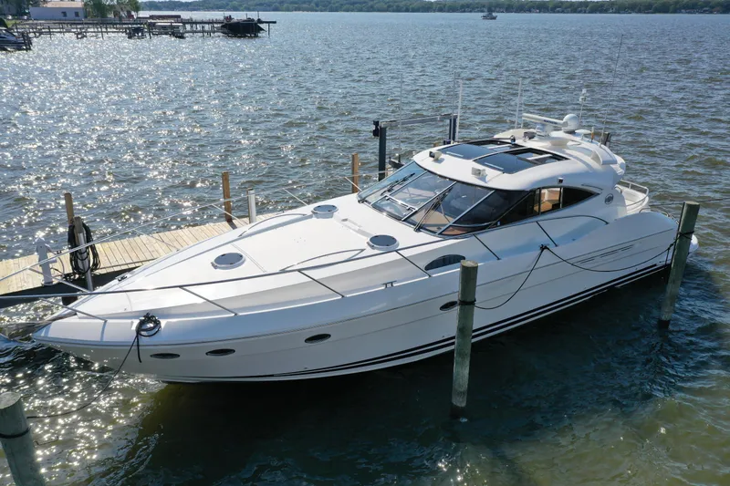 Slide: The Image of 2001 Neptunus 56 Express yacht docked on a sunny lake. - 1
