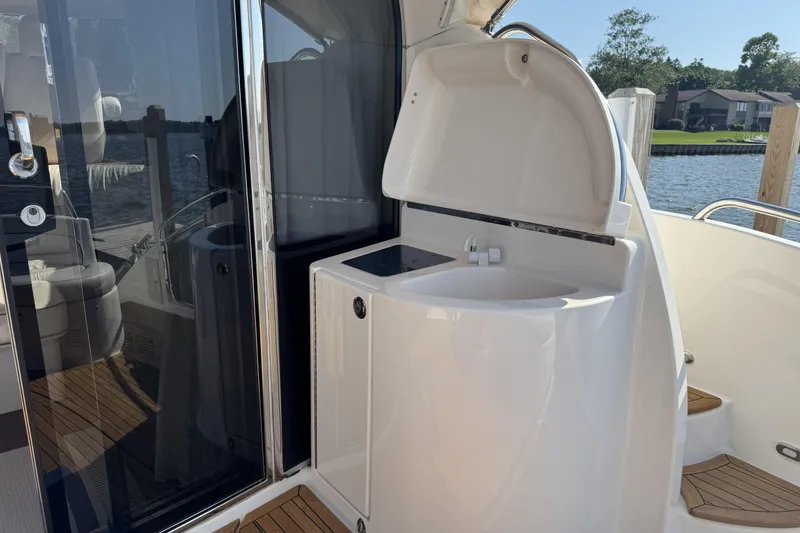 Slide: The Image of 2001 Neptunus 56 Express yacht with sleek outdoor sink and glass door. - 11