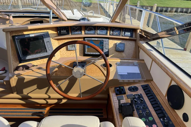 Slide: The Image of Helm of 2001 Neptunus 56 Express yacht with navigation equipment and wooden steering wheel. - 20