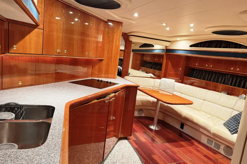 Slide: The Image of Luxurious interior of a 2001 Neptunus 56 Express yacht with wood cabinetry and plush seating. - 26