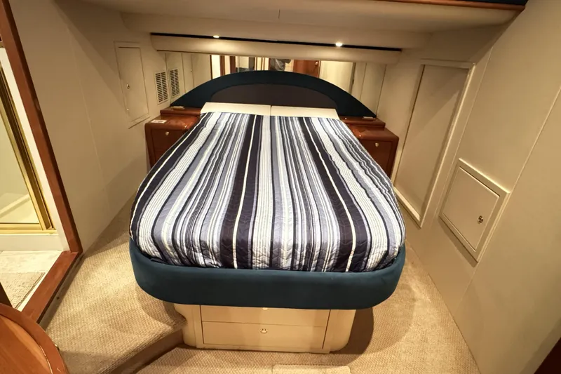 Slide: The Image of Luxurious cabin interior of 2001 Neptunus 56 Express yacht with striped bedding. - 28
