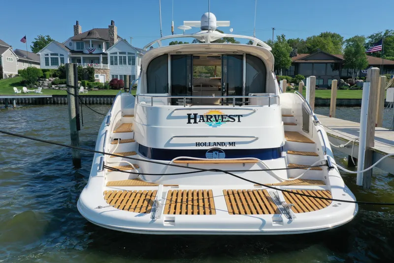 Slide: The Image of 2001 Neptunus 56 Express yacht docked in Holland, MI, with waterfront homes in the background. - 3