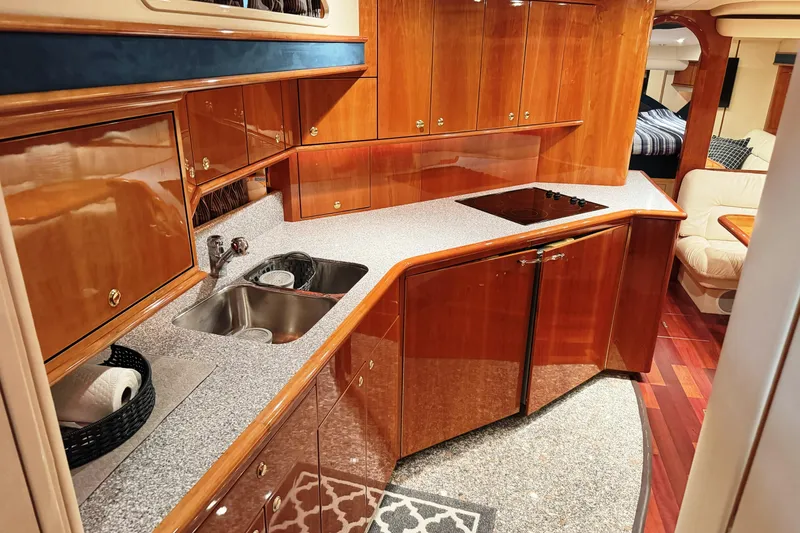 Slide: The Image of Luxurious kitchen interior of 2001 Neptunus 56 Express yacht with wood cabinetry and modern appliances. - 33