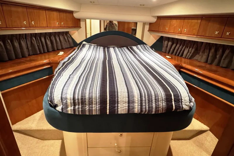 Slide: The Image of Luxurious cabin interior of 2001 Neptunus 56 Express yacht with striped bedding. - 36