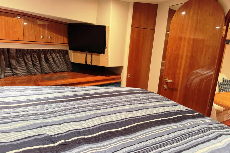 Slide: The Image of Luxurious cabin interior of 2001 Neptunus 56 Express yacht with wood finishes and TV. - 38