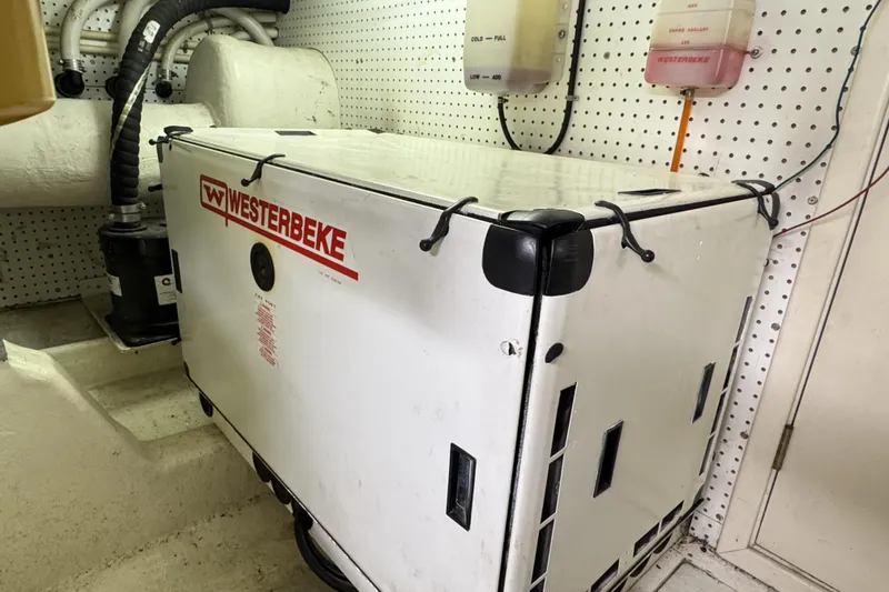 Slide: The Image of Westerbeke generator in 2001 Neptunus 56 Express engine room, with coolant containers above. - 49
