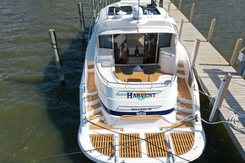Slide: The Image of 2001 Neptunus 56 Express yacht docked, featuring spacious deck and elegant design. - 6