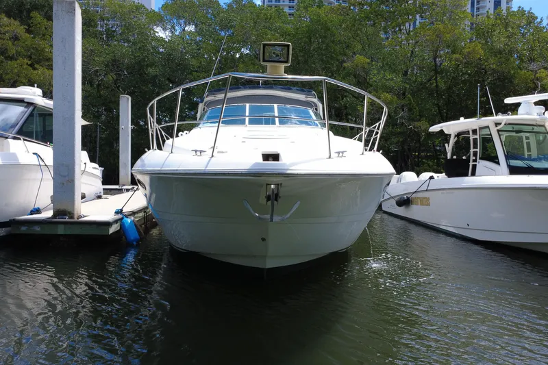 Slide: The Image of 1999 Cruisers Yachts 3870 Esprit docked between two boats in a marina. - 11