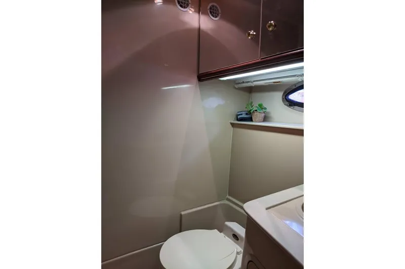 Slide: The Image of 1999 Cruisers Yachts 3870 Esprit bathroom interior with toilet and porthole window. - 19