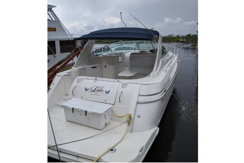 Slide: The Image of 1999 Cruisers Yachts 3870 Esprit docked among other boats at a marina. - 2