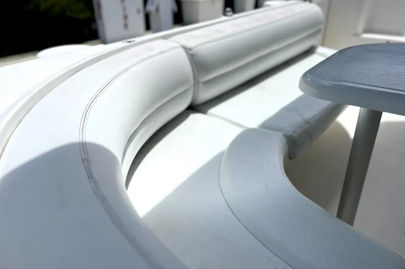 Slide: The Image of 1999 Cruisers Yachts 3870 Esprit interior seating with white upholstery and table. - 21