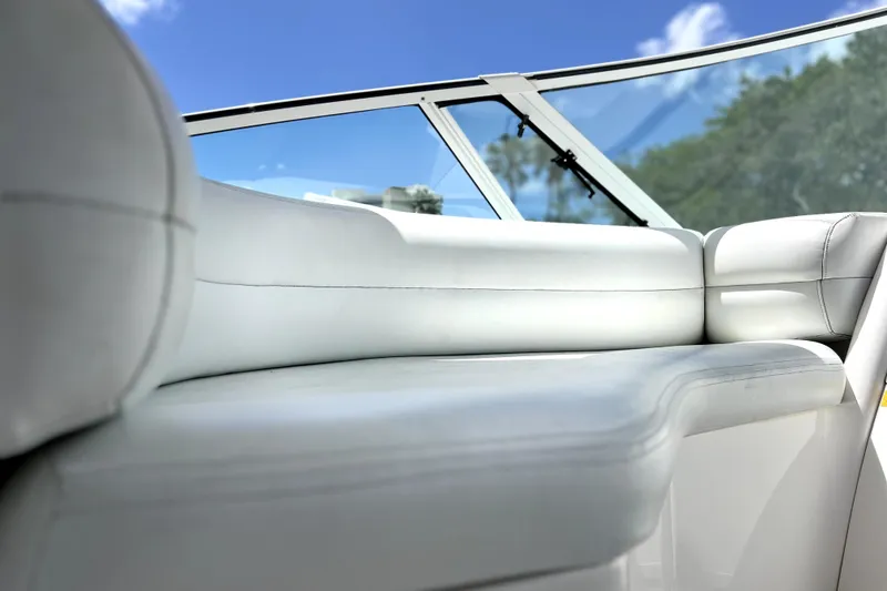 Slide: The Image of 1999 Cruisers Yachts 3870 Esprit interior with white leather seating and clear blue sky. - 24