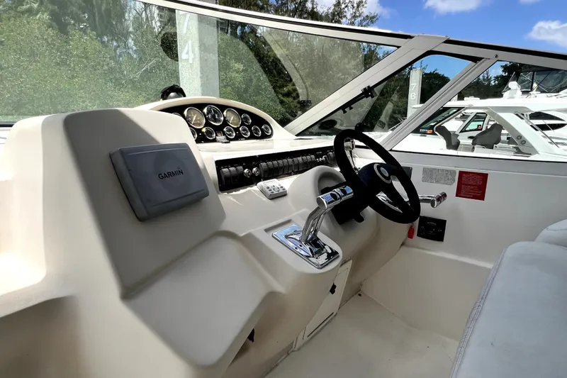 Slide: The Image of 1999 Cruisers Yachts 3870 Esprit helm with Garmin navigation and sleek steering controls. - 26