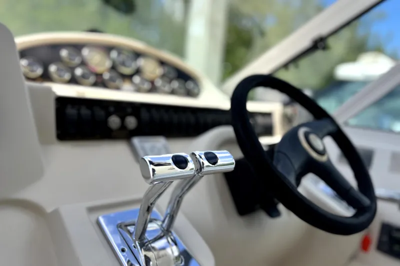 Slide: The Image of 1999 Cruisers Yachts 3870 Esprit helm with steering wheel and throttle controls. - 28