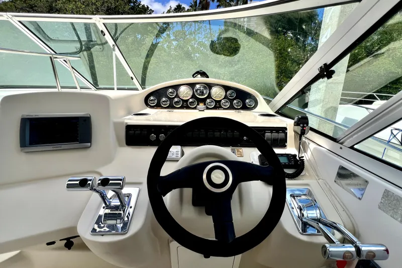 Slide: The Image of 1999 Cruisers Yachts 3870 Esprit helm with steering wheel and control panel. - 29