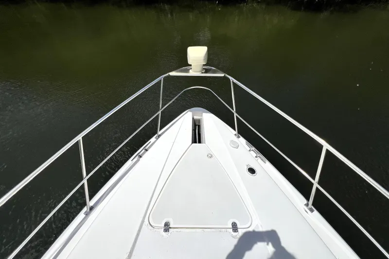 Slide: The Image of Bow view of 1999 Cruisers Yachts 3870 Esprit on calm water. - 44