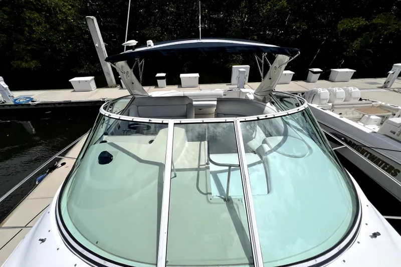 Slide: The Image of 1999 Cruisers Yachts 3870 Esprit docked, showcasing sleek design and spacious cockpit. - 50