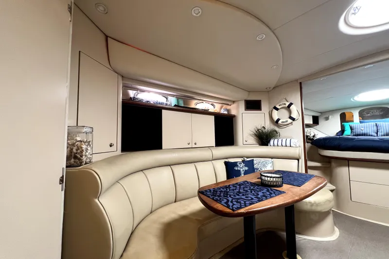 Slide: The Image of Interior of 1999 Cruisers Yachts 3870 Esprit with cozy seating and nautical decor. - 59