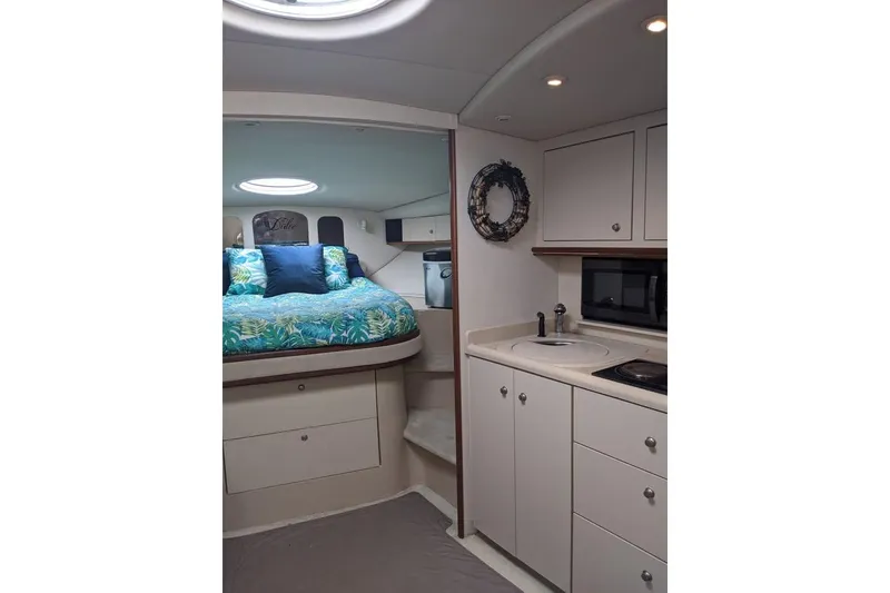 Slide: The Image of 1999 Cruisers Yachts 3870 Esprit docked, featuring sleek design and spacious deck. - 6