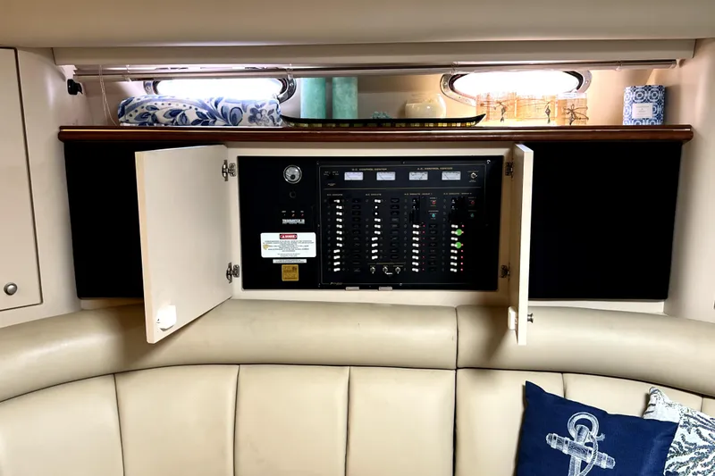 Slide: The Image of Electrical panel inside 1999 Cruisers Yachts 3870 Esprit, with open cabinet doors. - 62