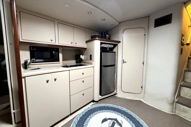 Slide: The Image of 1999 Cruisers Yachts 3870 Esprit interior kitchen with cabinets, microwave, and fridge. - 66