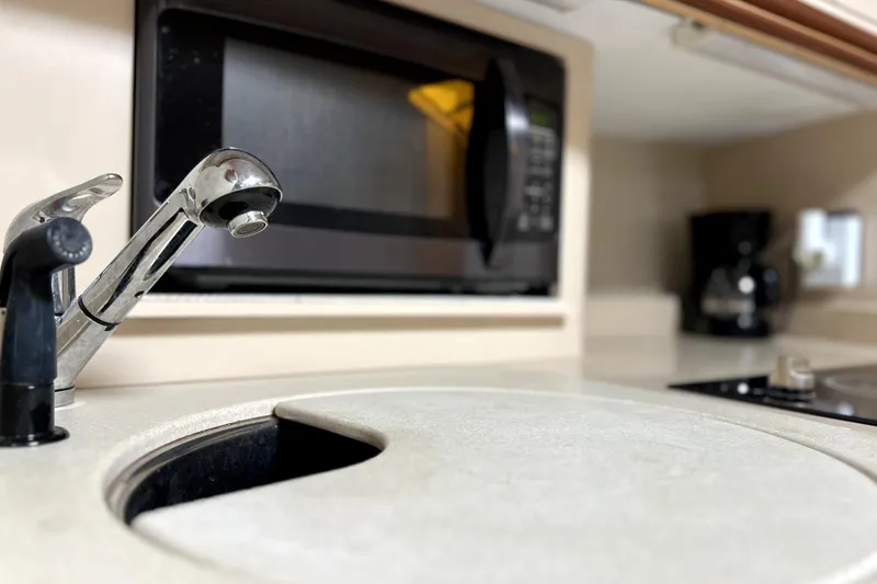 Slide: The Image of 1999 Cruisers Yachts 3870 Esprit kitchen with sink, microwave, and coffee maker. - 67