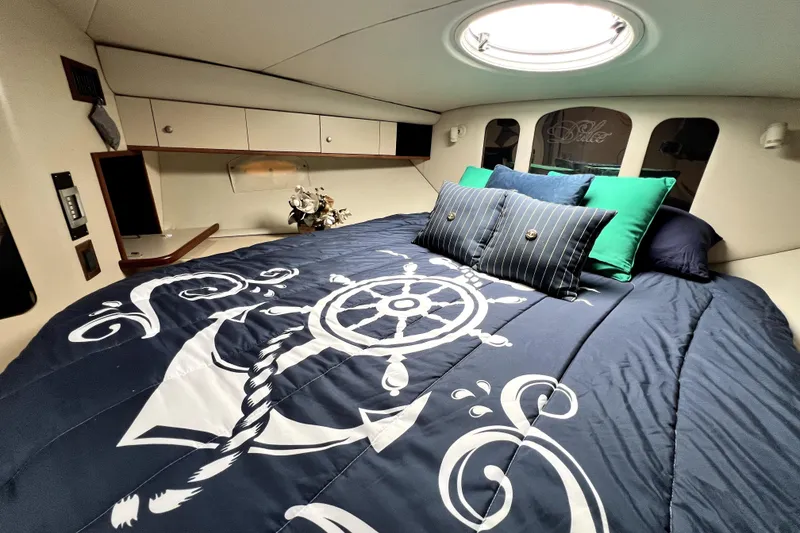 Slide: The Image of Luxurious cabin interior of 1999 Cruisers Yachts 3870 Esprit with nautical-themed bedding. - 76