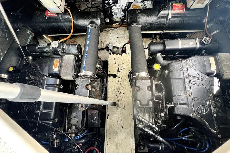 Slide: The Image of Engine compartment of a 1999 Cruisers Yachts 3870 Esprit, showcasing dual V8 engines. - 83
