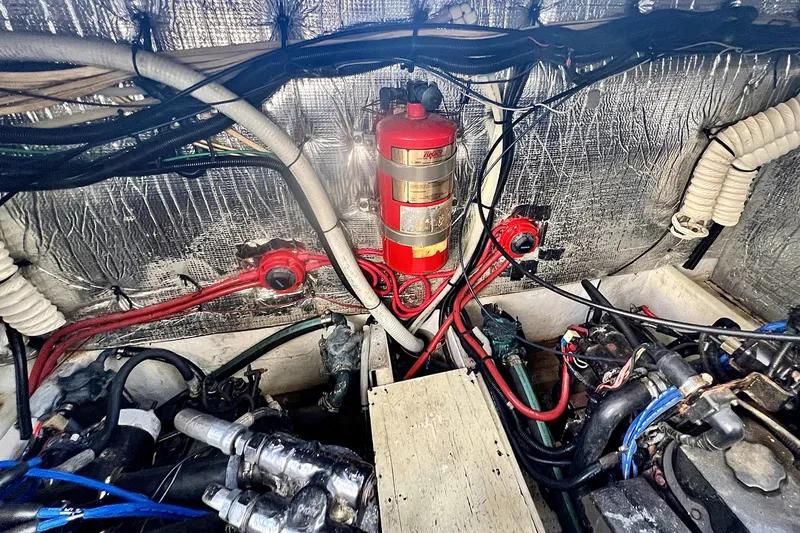 Slide: The Image of Engine room of 1999 Cruisers Yachts 3870 Esprit with fire extinguisher and wiring. - 84