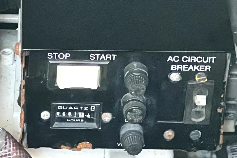 Slide: The Image of Control panel of a 1999 Cruisers Yachts 3870 Esprit with start, stop, and AC circuit breaker. - 86