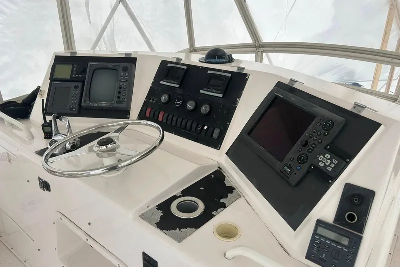 Slide: The Image of Control panel of a 1995 Bertram 43 Convertible yacht with navigation equipment. - 16