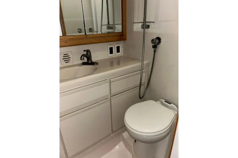 Slide: The Image of Bathroom interior of 1995 Bertram 43 Convertible yacht, featuring sink and toilet. - 18