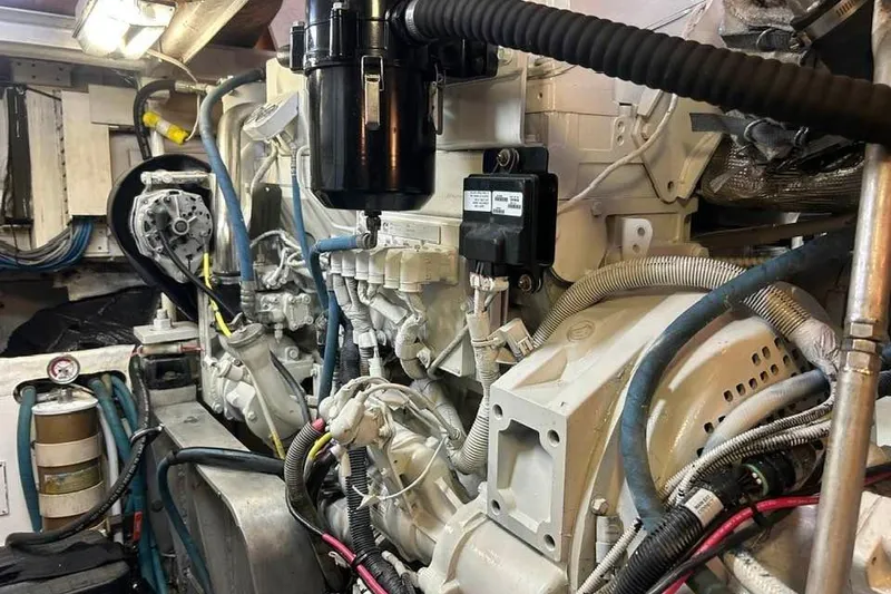 Slide: The Image of Engine room of a 1995 Bertram 43 Convertible boat, showcasing mechanical components. - 21